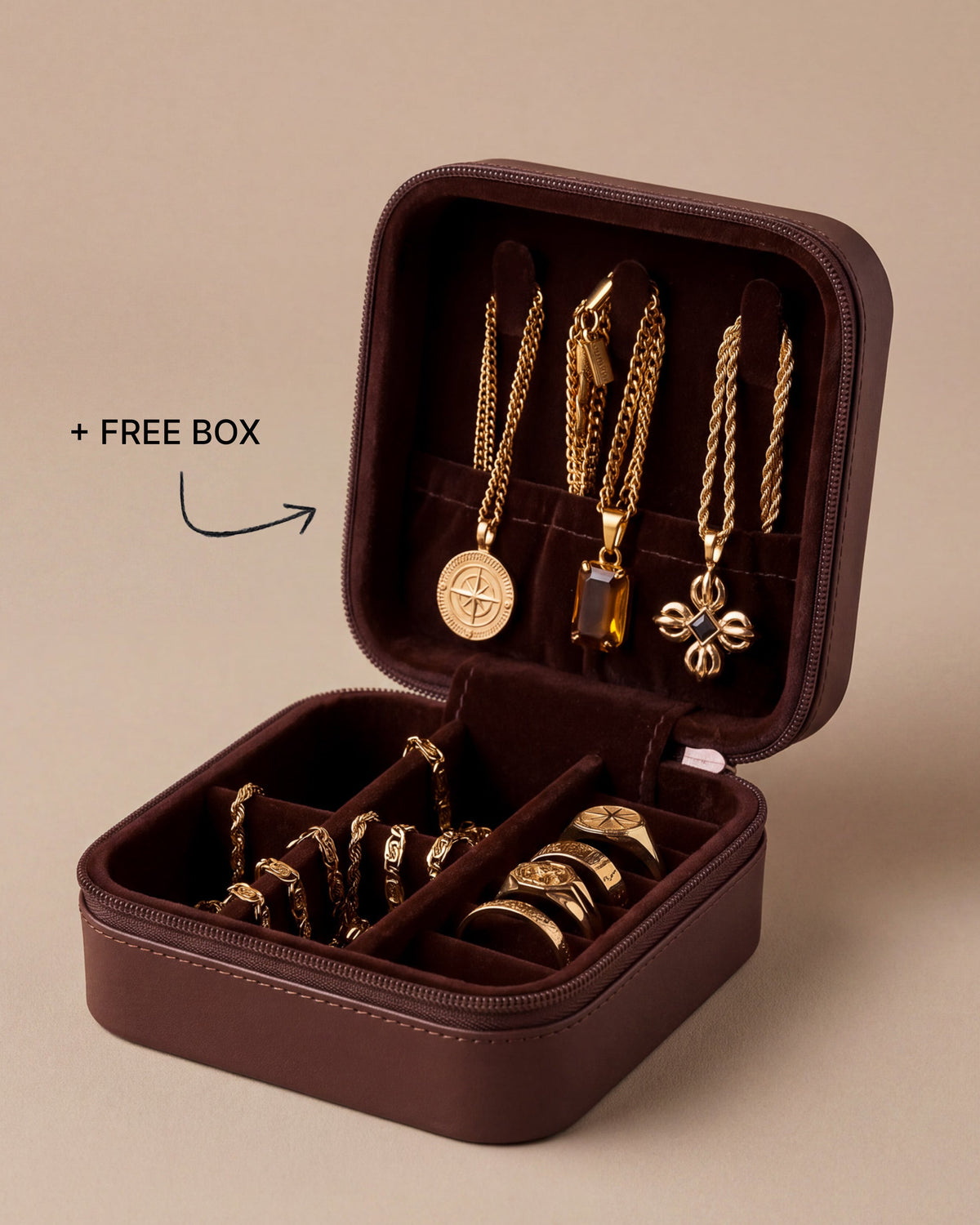 Open brown travel jewelry case with the free box offer, holding three gold pendant necklaces, gold chain bracelets and signet rings