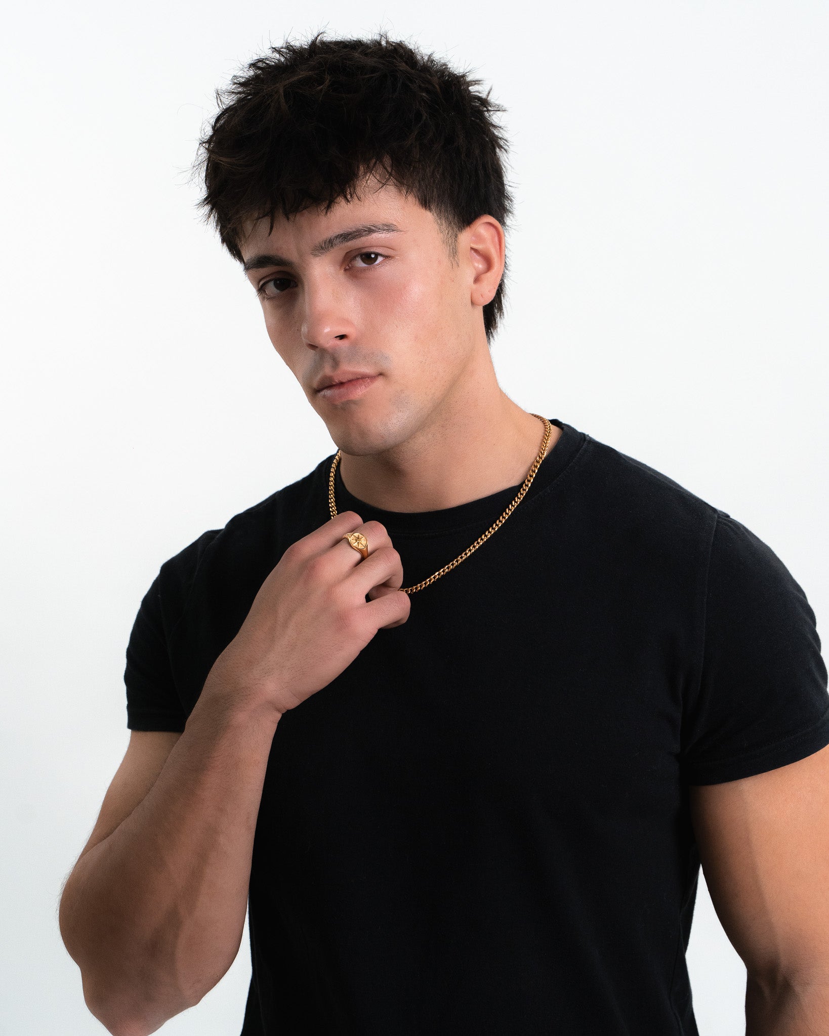 Model wearing a 5mm Cuban link gold chain around the neck with a ring on the finger