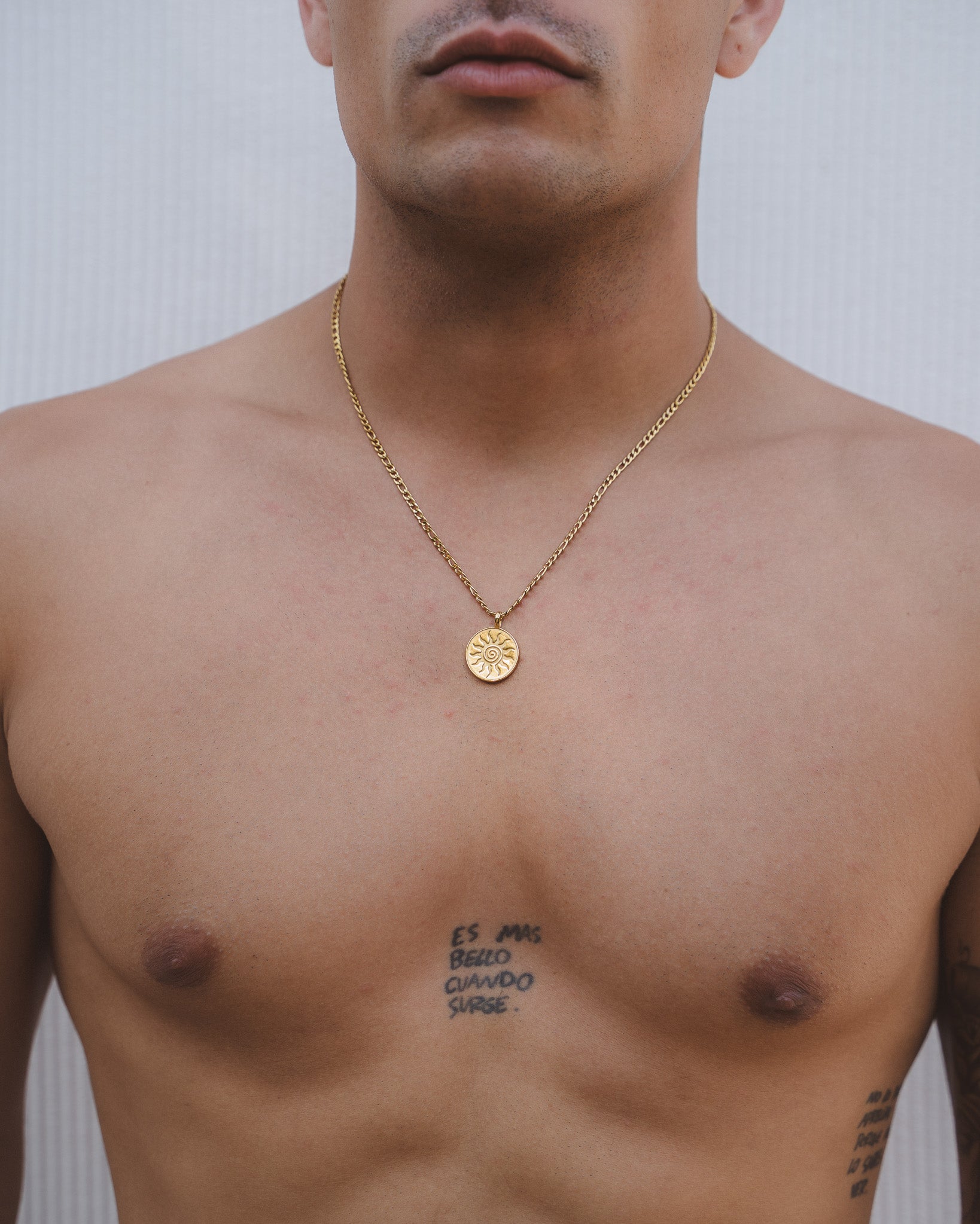 Energy Gold Necklace worn by a man featuring a gold chain and round pendant