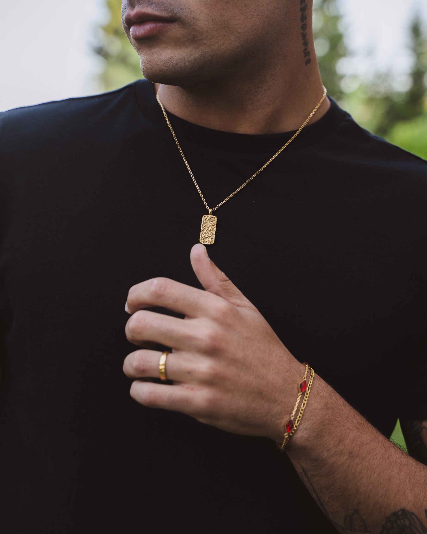 Back of neck wearing Moonrock gold necklace with textured pendant and beaded chain