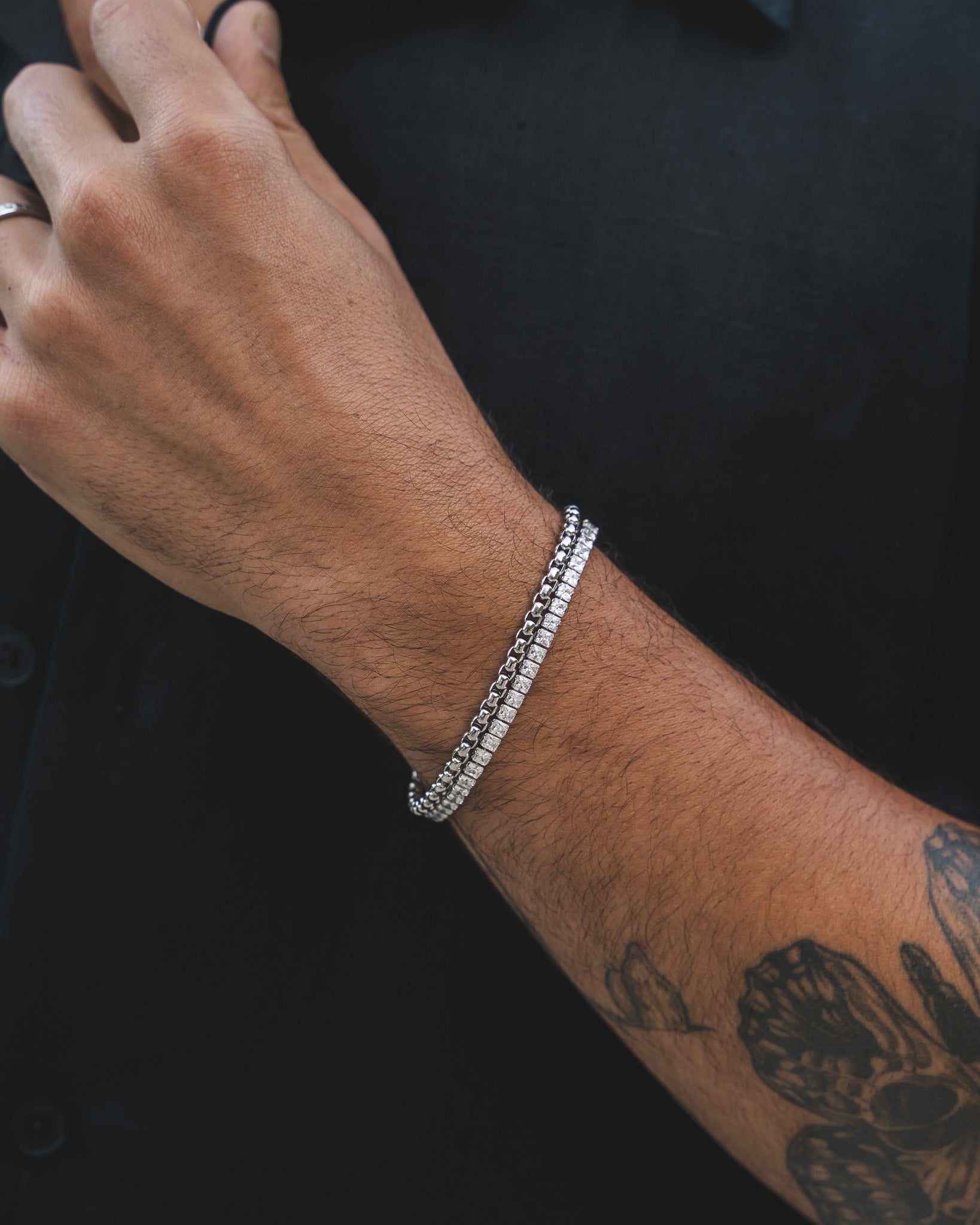 Close up of a man's wrist wearing a 4 mm icy tennis bracelet with zircon stones