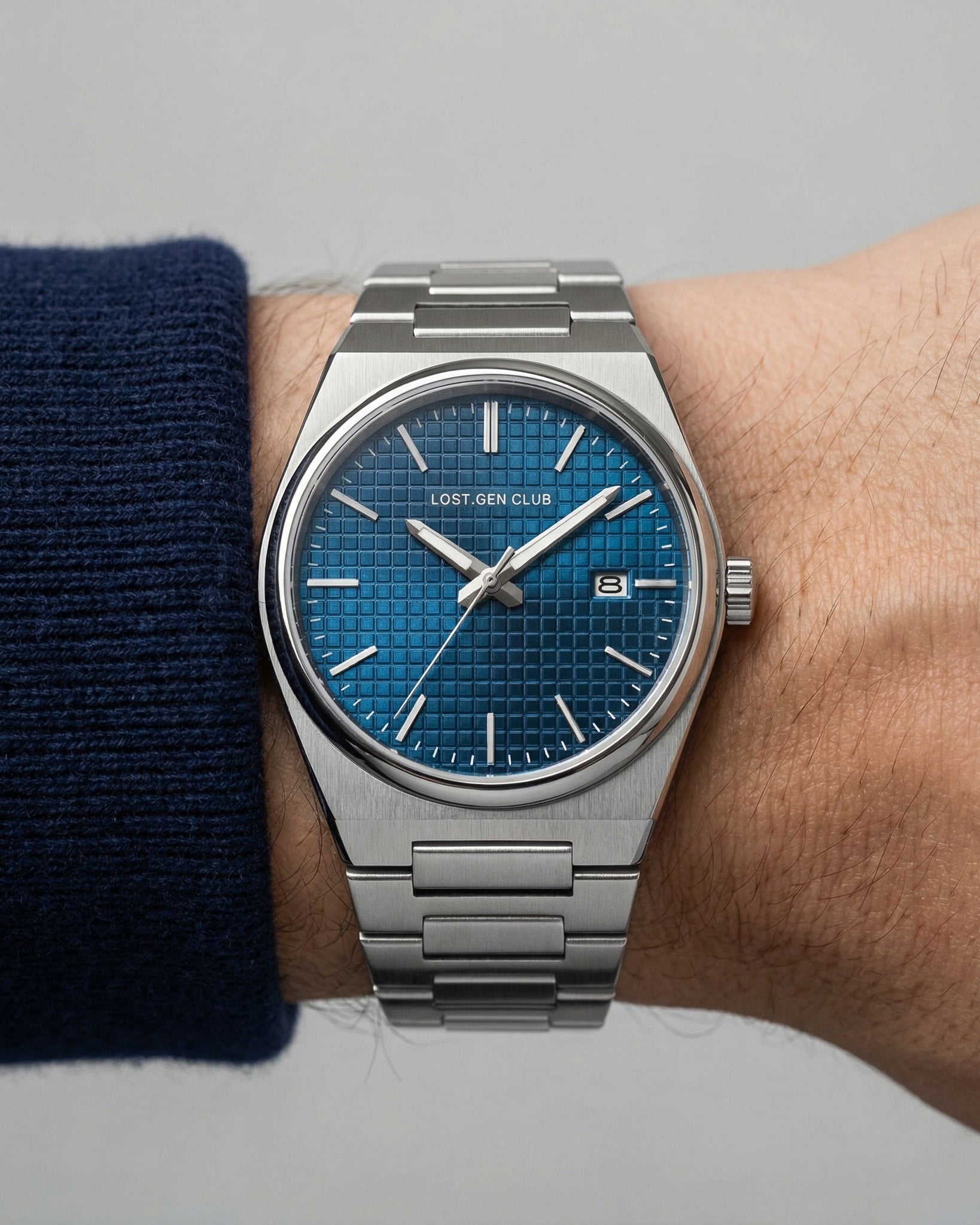 Close up of AUREN watch dial featuring blue grid face with Lost Gen Club branding