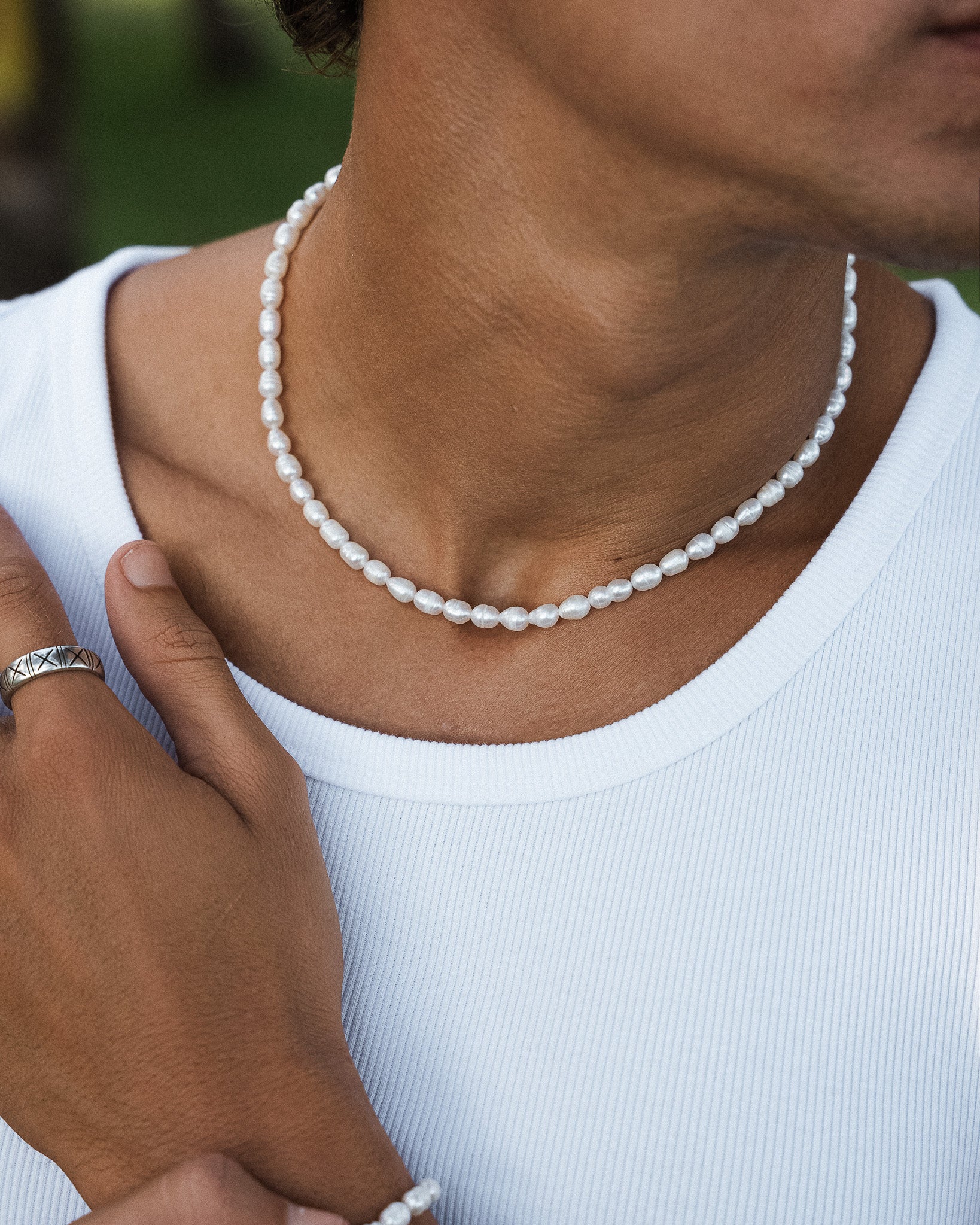 Belize Pearl Chain necklace with white pearls draped around the wearer's neck.