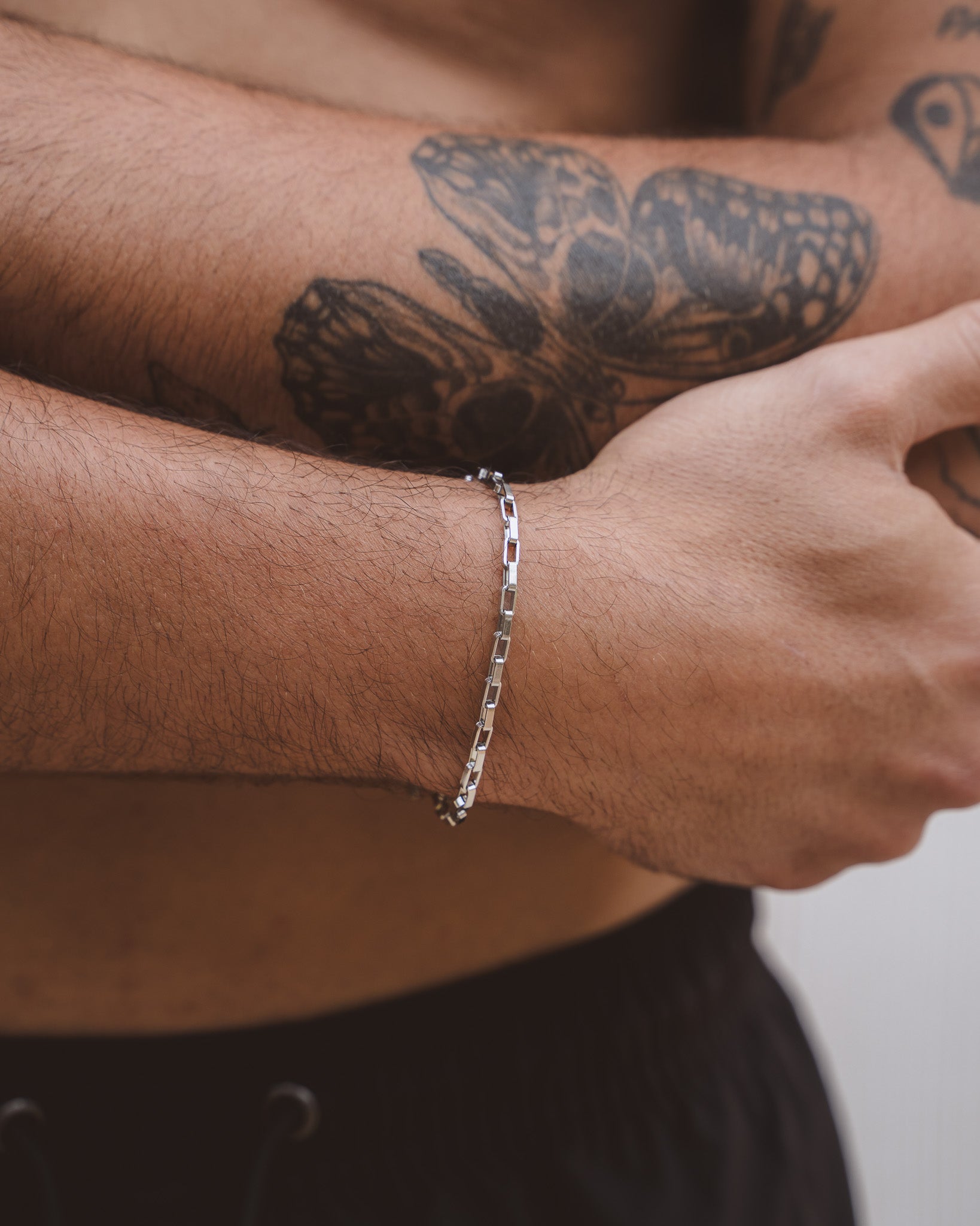 Capri silver bracelet on a tattooed forearm; slim 3 mm chain with adjustable length