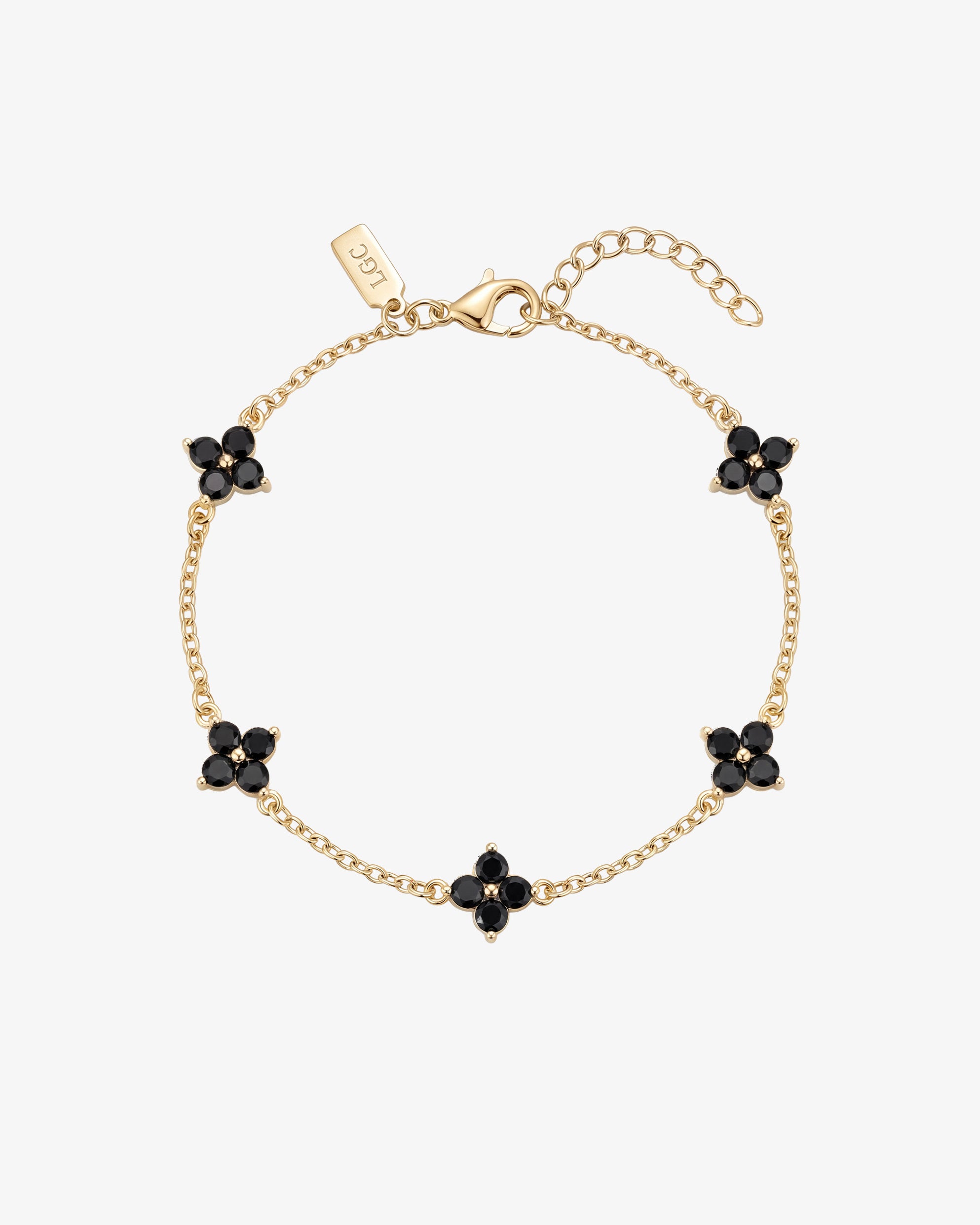 Gold Clover bracelet with black gemstone flower charms along a delicate chain