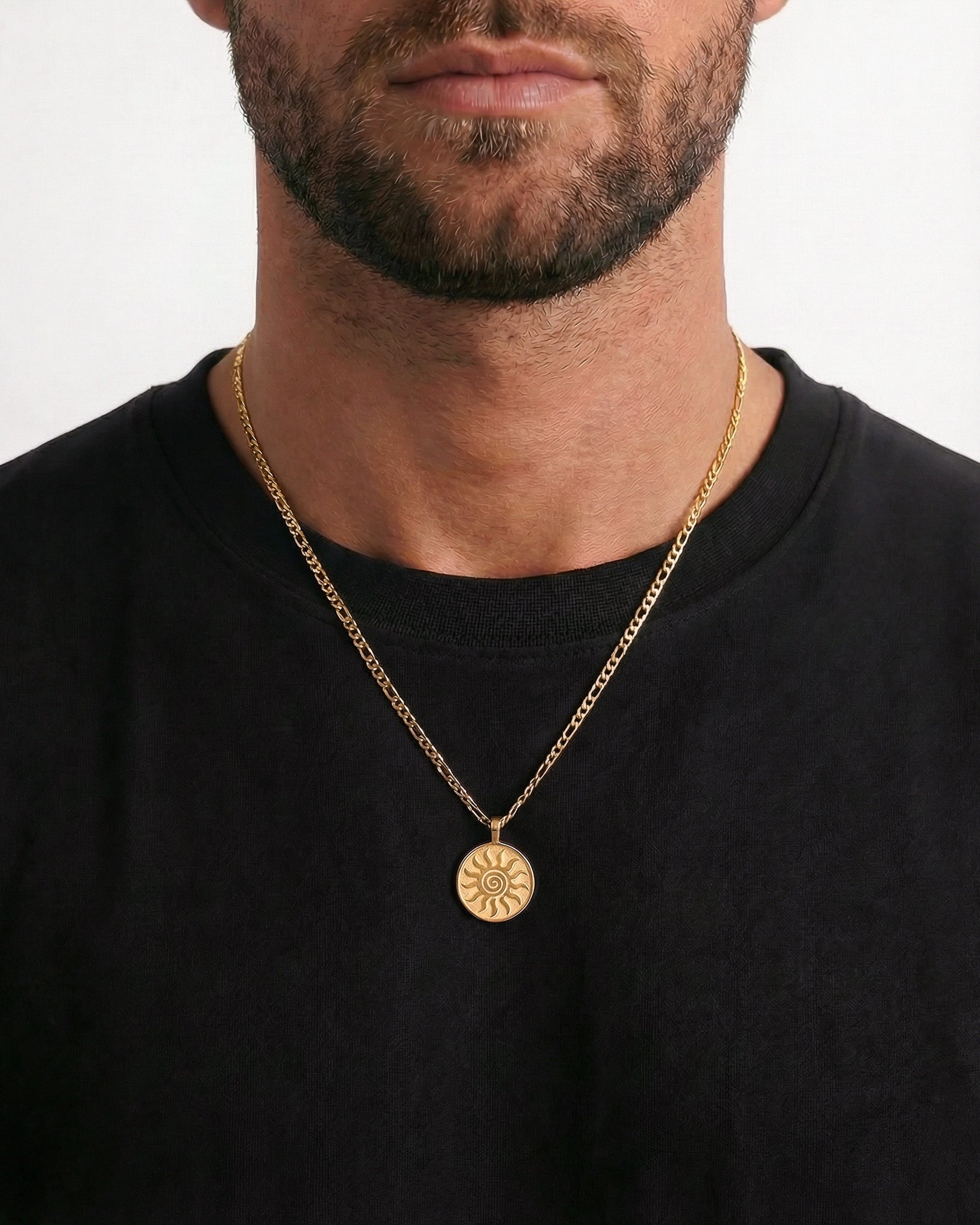 Gold energy necklace shown on a black shirt with the sun medallion pendant visible.