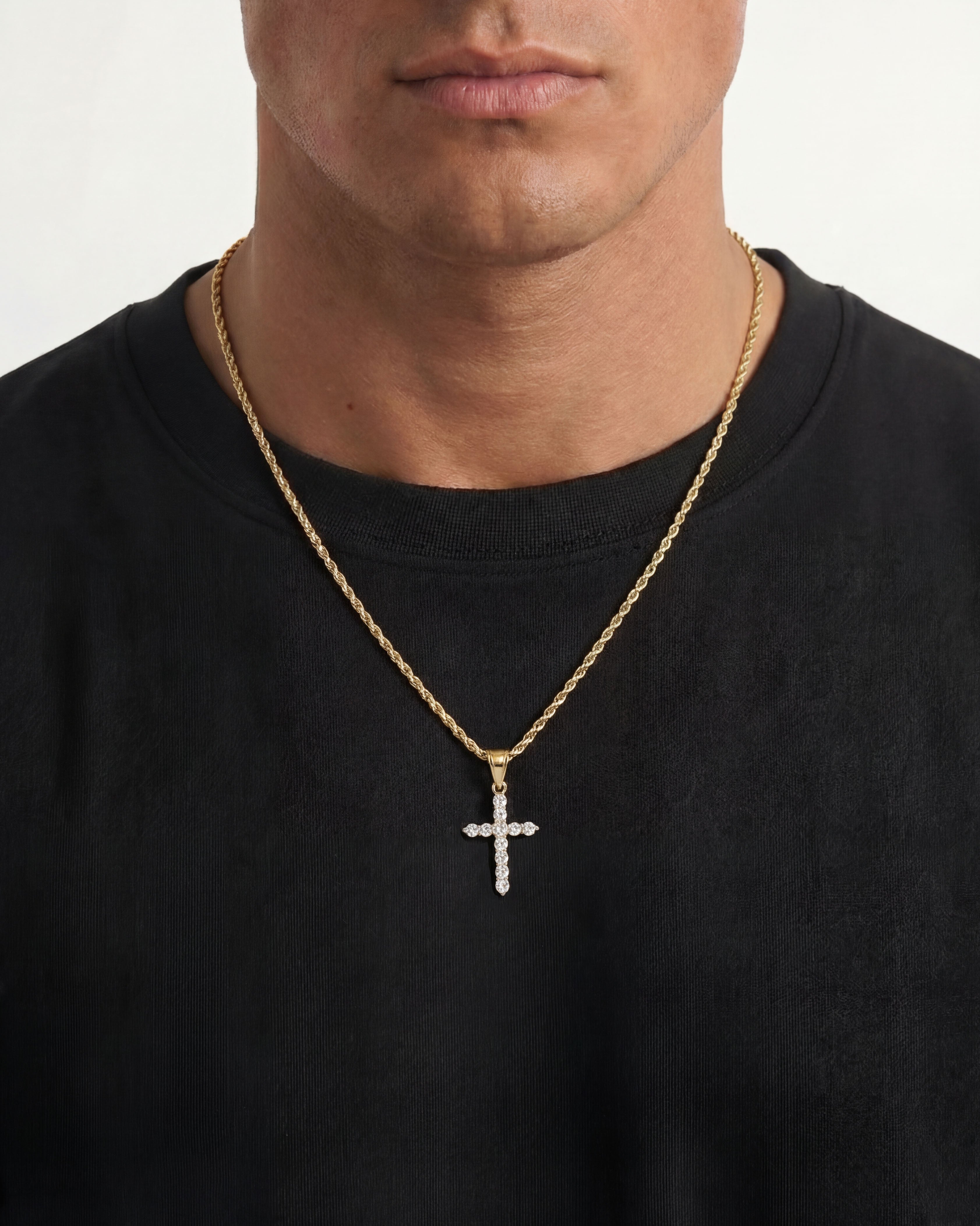 Model wearing ICY CROSS Gold Necklace with a sparkling cross pendant against a black shirt