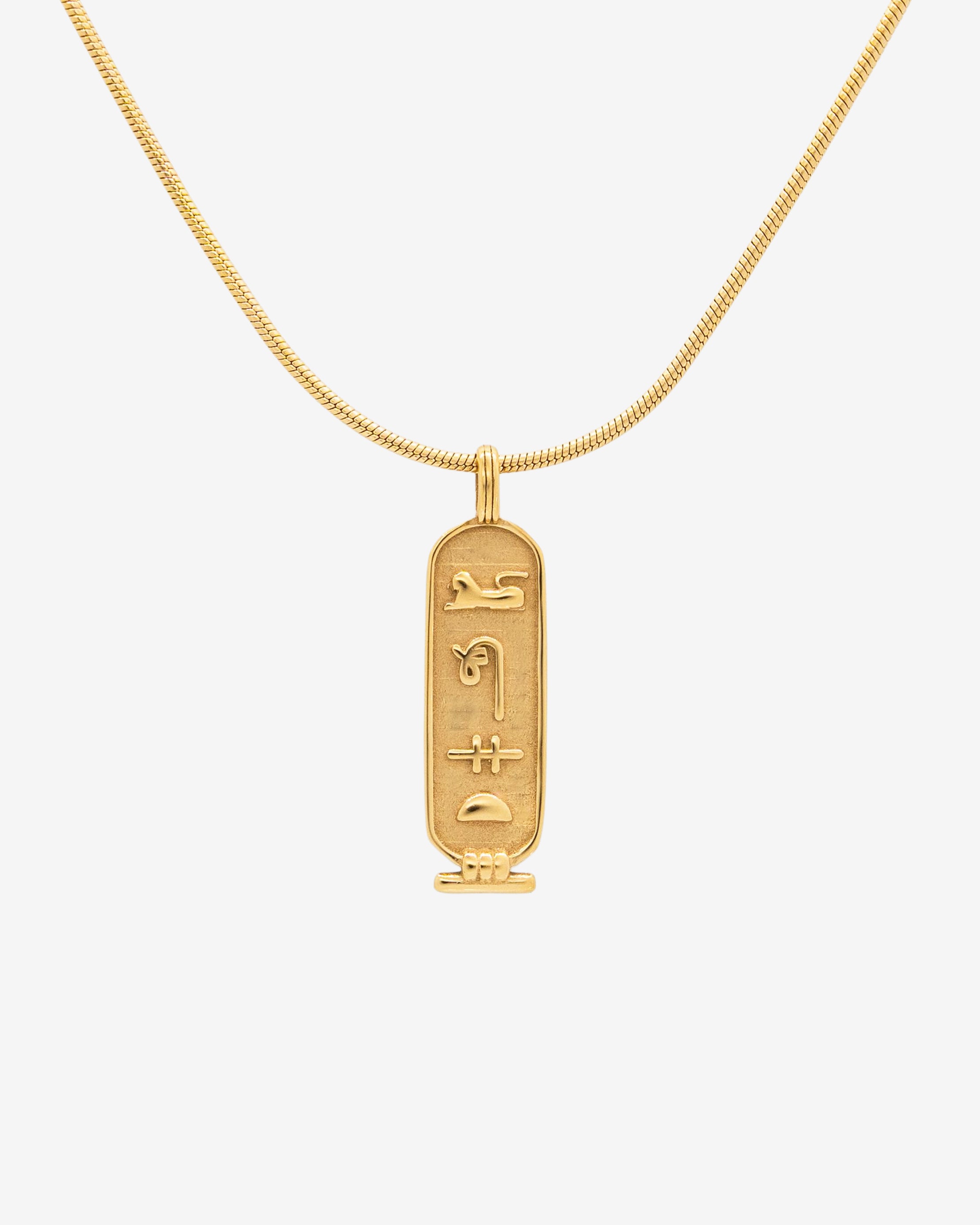 Luxor Gold Necklace close up with curved chain and rectangular pendant engraved with hieroglyphs
