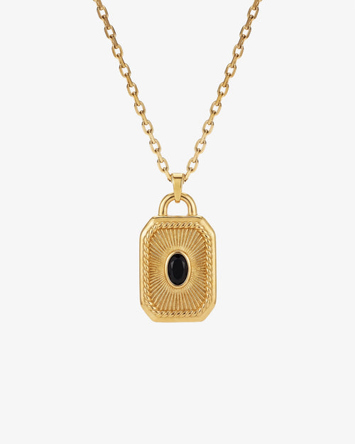 Gold necklace with a rectangular padlock pendant and a central black gemstone