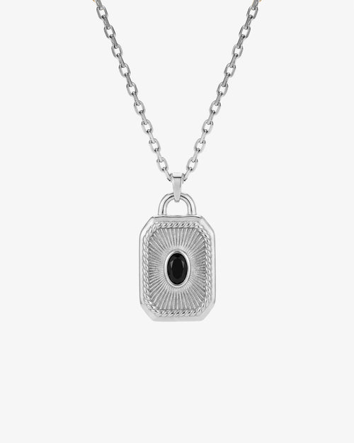 Silver necklace with a four loop clover style pendant and a central black gemstone