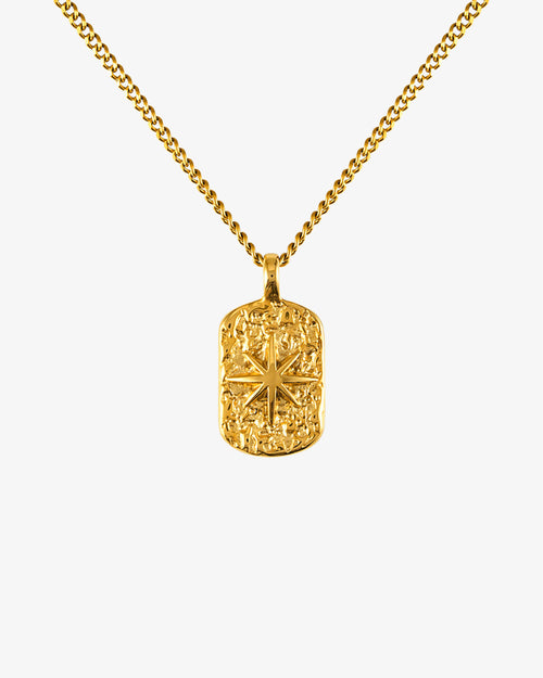 Gold IBZ necklace with a 50 cm chain plus 5 cm adjustable and a small round pendant worn by a model