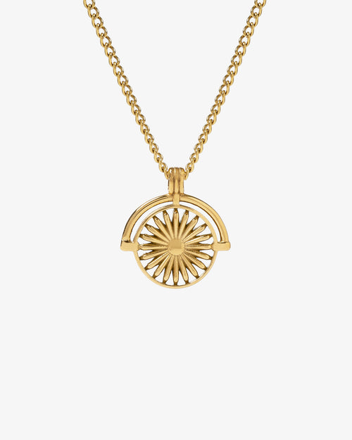 Gold Daisy necklace with sunburst pendant on a gold chain worn by a man.