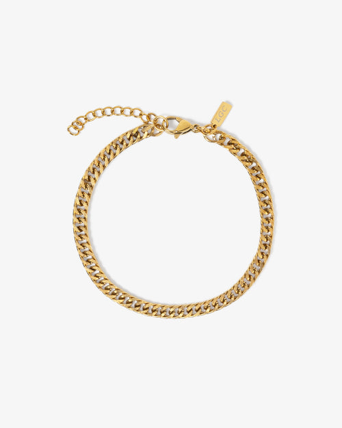 Gold coral chain bracelet with adjustable extension worn on the wrist