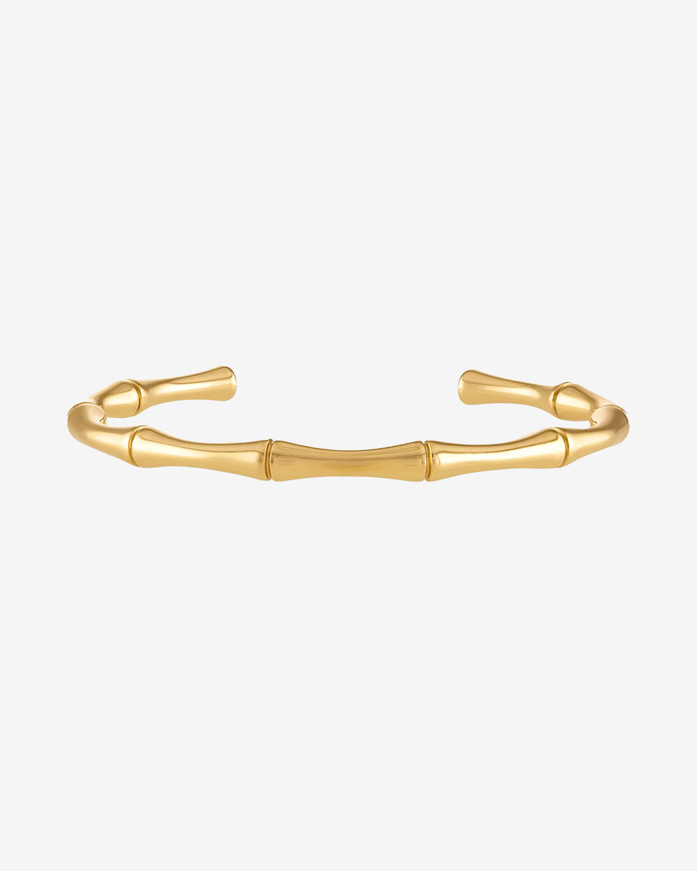 Pulsera dorada de bambú con eslabones segmentados en una muñeca.