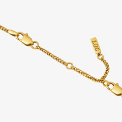 Eight centimeter gold extender chain with lobster clasp and small tag detail