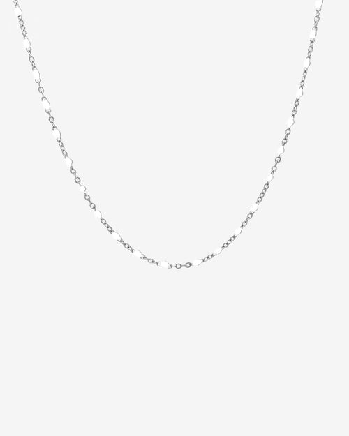 Delicate silver chain necklace with small white beads evenly spaced along the links