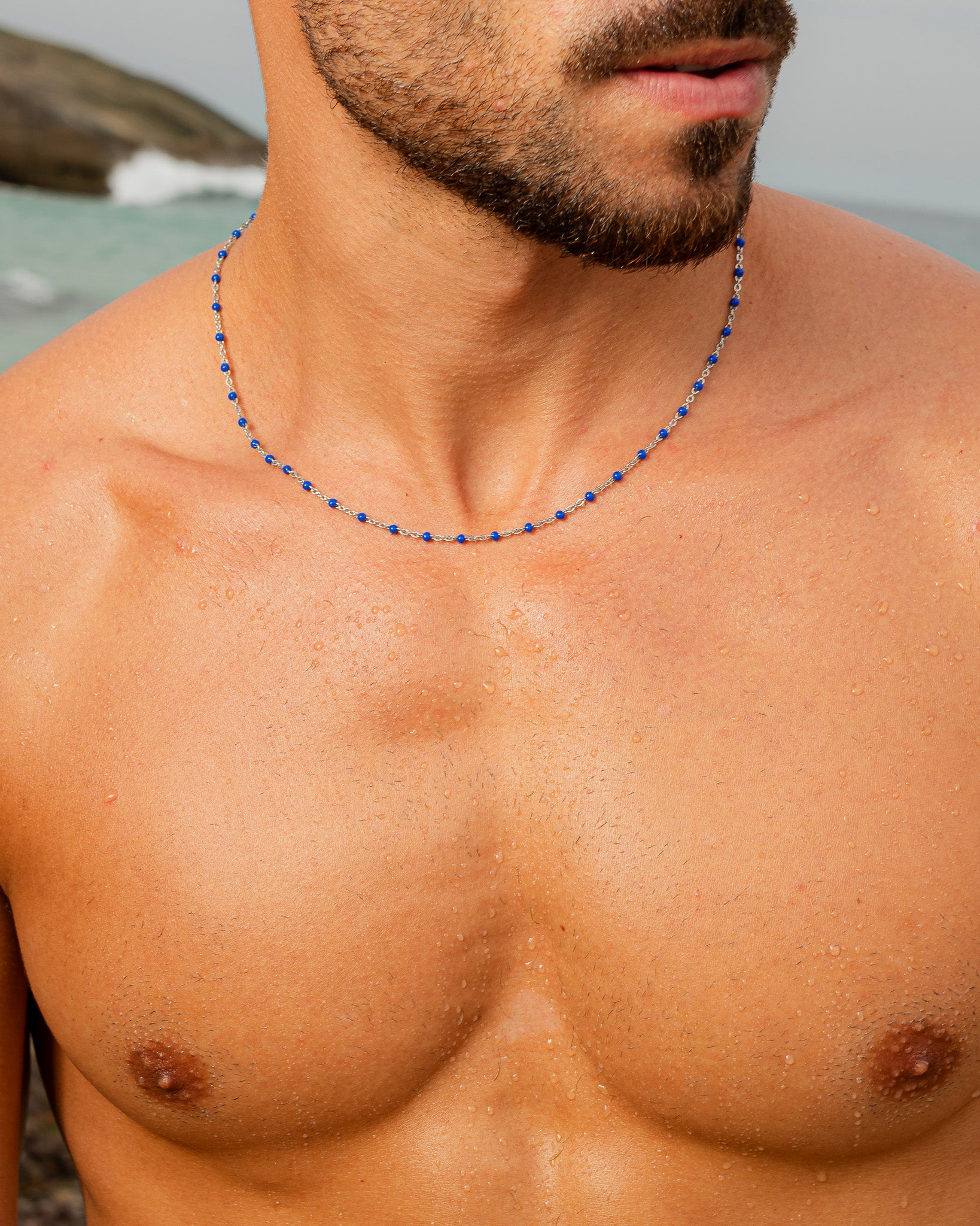 GEM silver chain necklace with blue beads resting at the collarbone