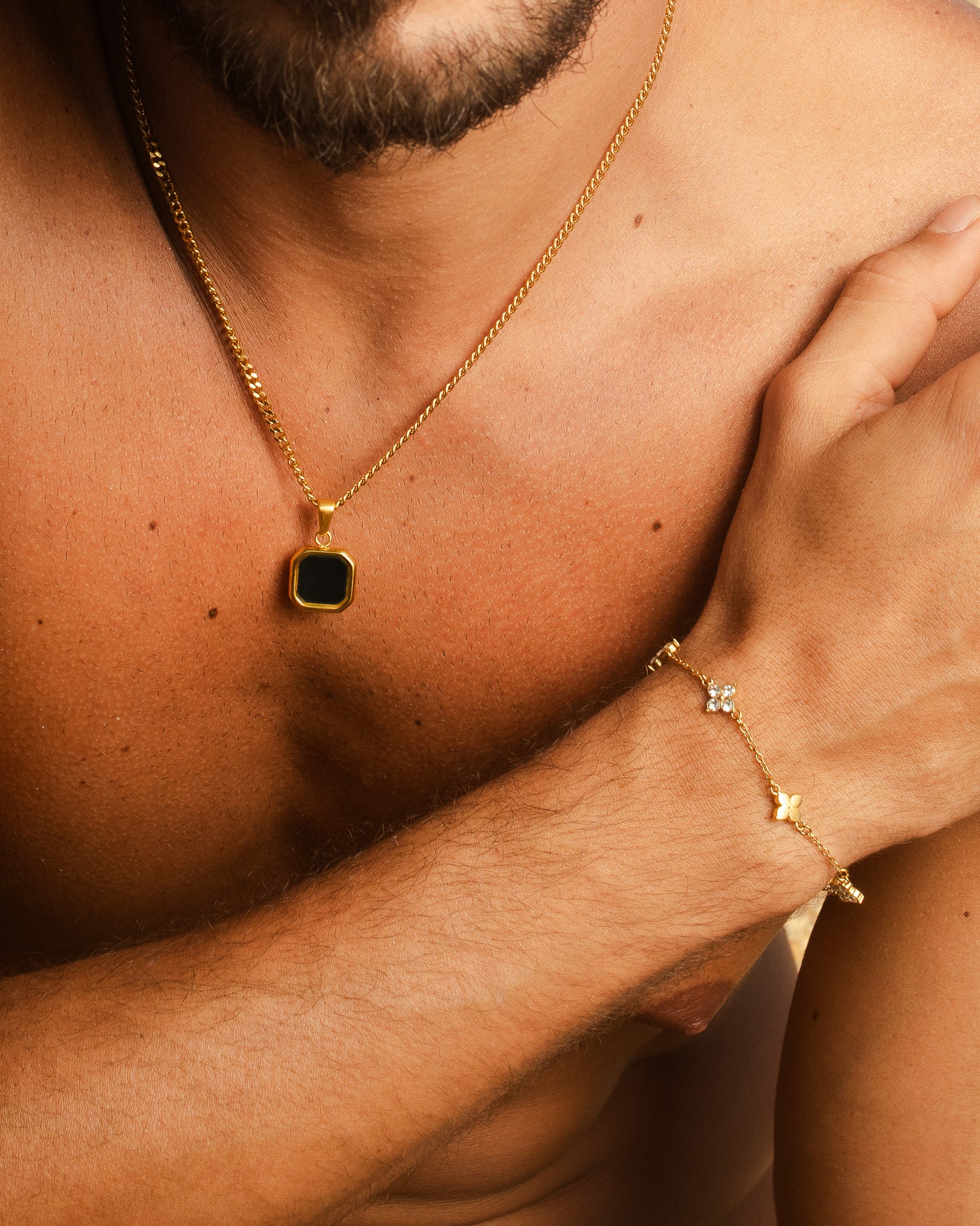 Nova Gold necklace with a square black onyx pendant resting on the chest