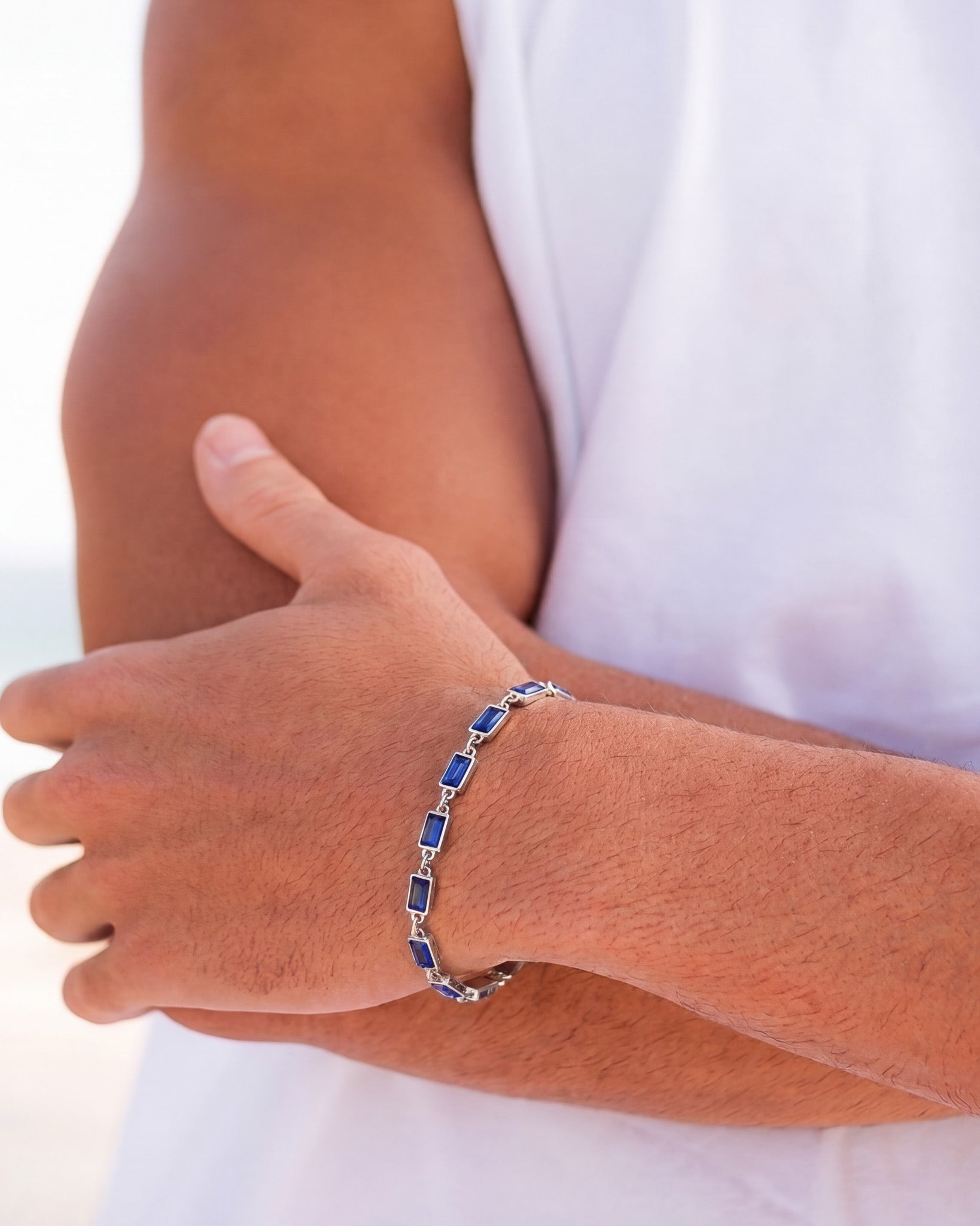 Omen silver bracelet with blue rectangular stones worn on the wrist