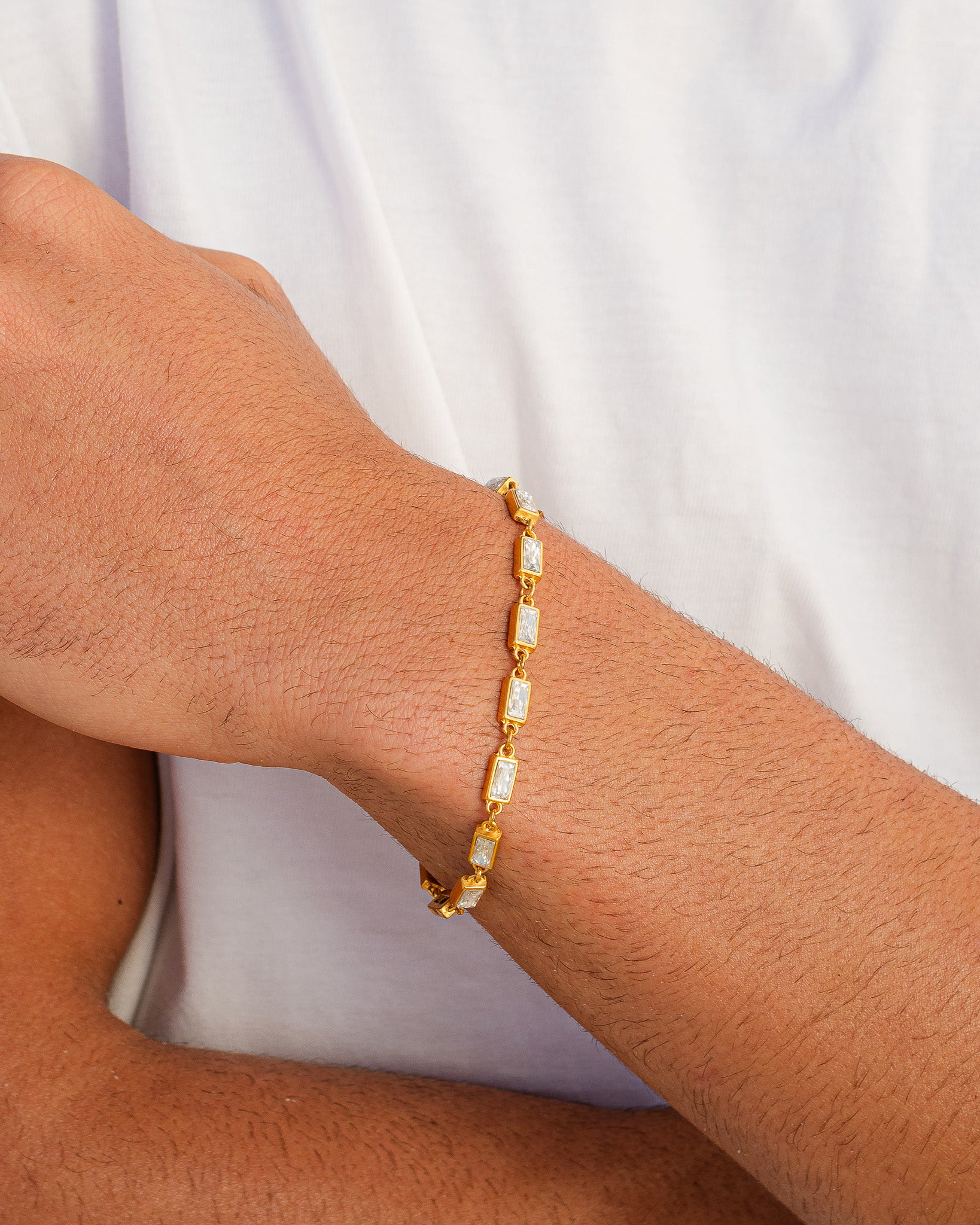 OMEN GOLD BRACELET featuring square clear stones along a delicate gold chain on the wrist