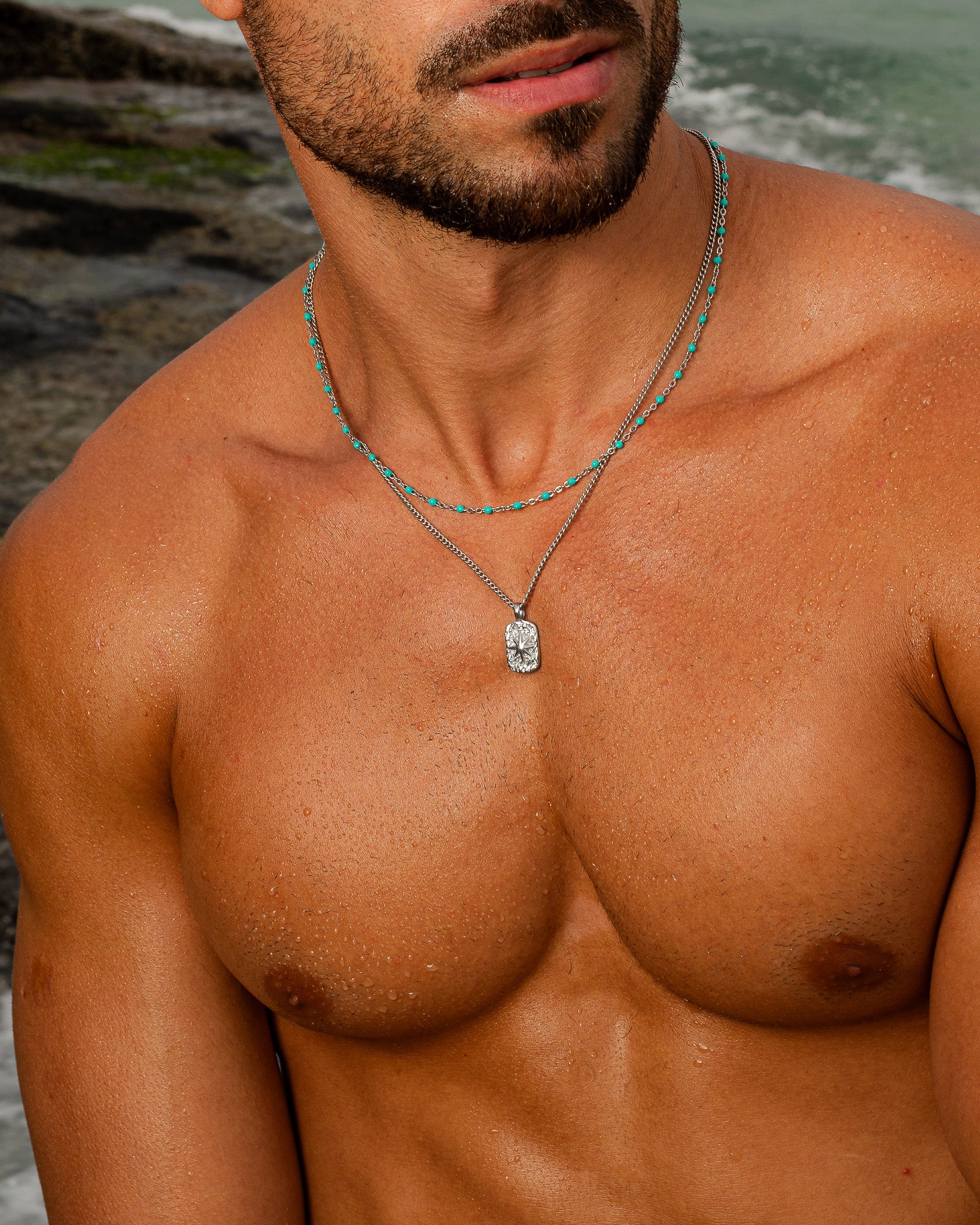 Turquoise bead accented IBZ Silver Necklace with a pendant worn by a man