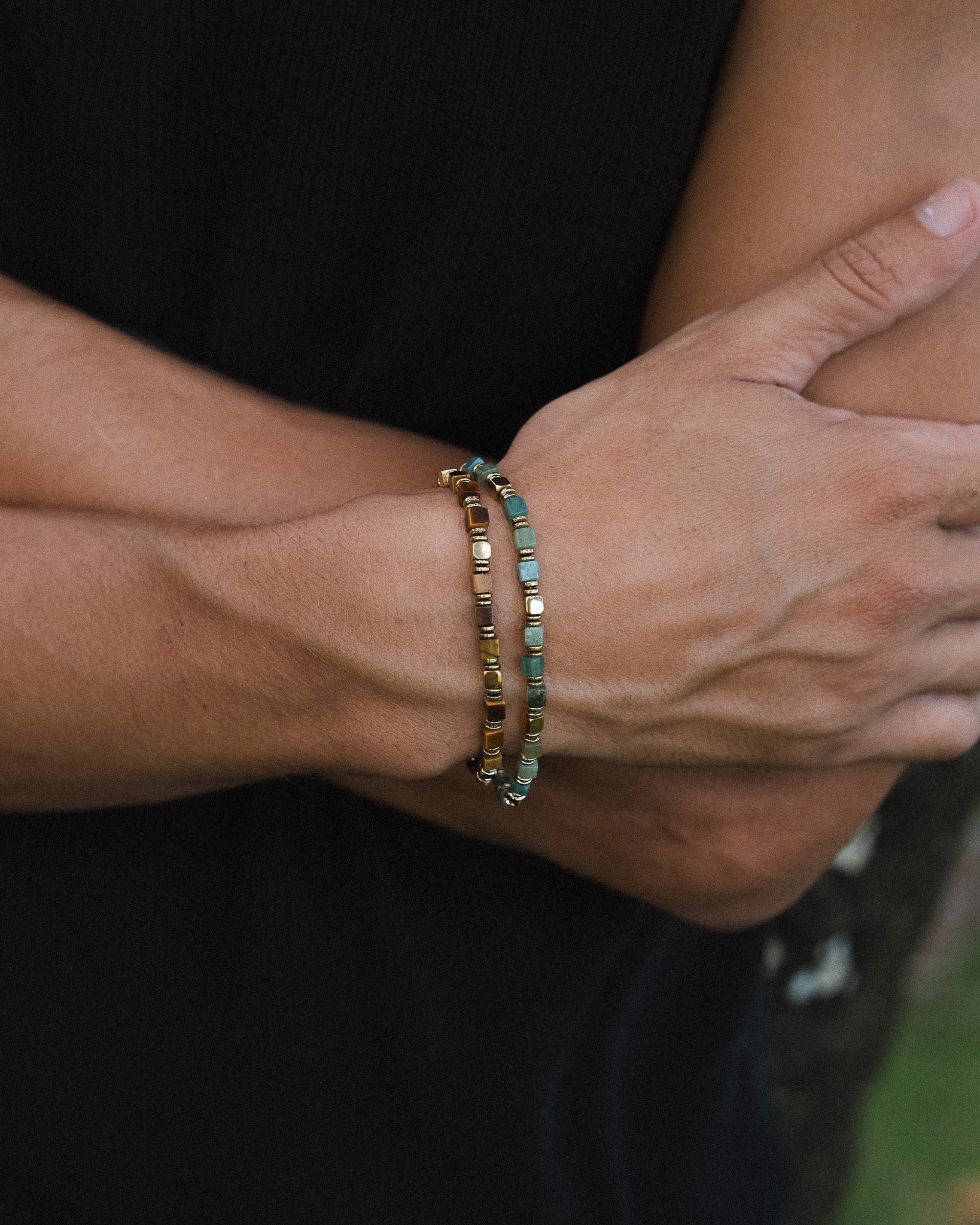 Model wearing tiger eye and hematite beaded bracelets on the wrist